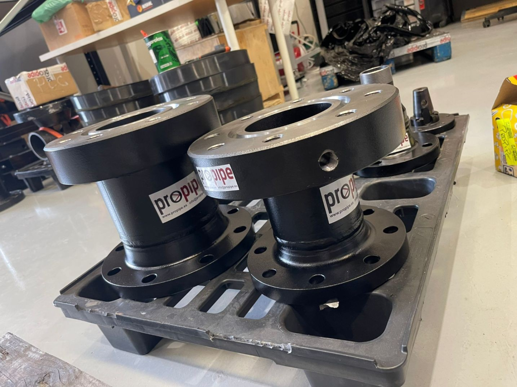 Set of Propipe industrial pipe hot tap & flange valve adapters arranged in a molded plastic tray on a workshop floor